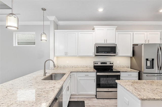 kitchen with decorative light fixtures, white cabinetry, sink, and appliances with stainless steel finishes