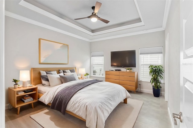 bedroom with ceiling fan, crown molding, and a tray ceiling