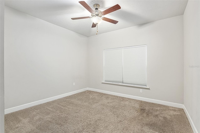 spare room featuring carpet and ceiling fan