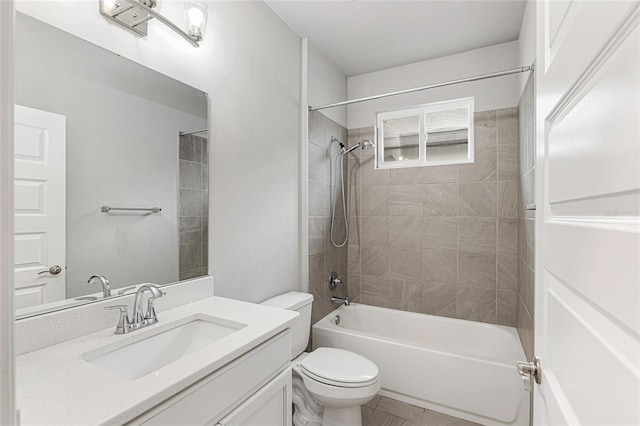 full bathroom with tile patterned flooring, toilet, vanity, and tiled shower / bath