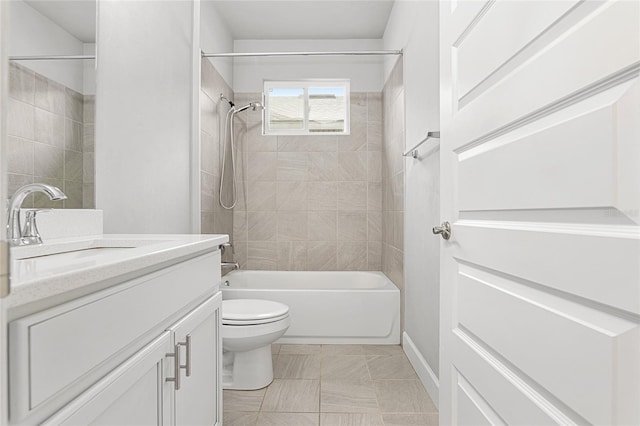 full bathroom with vanity, toilet, and tiled shower / bath