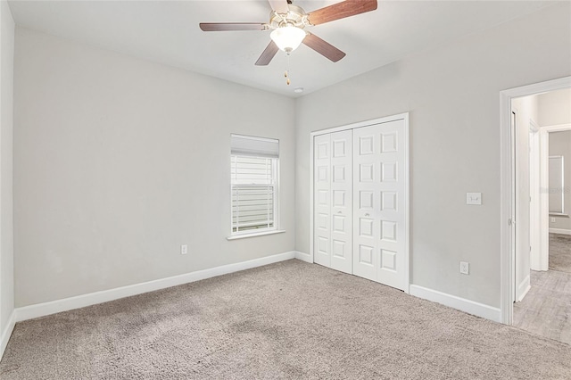 unfurnished bedroom featuring carpet flooring, a closet, and ceiling fan