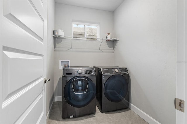 laundry area featuring separate washer and dryer and light tile patterned floors