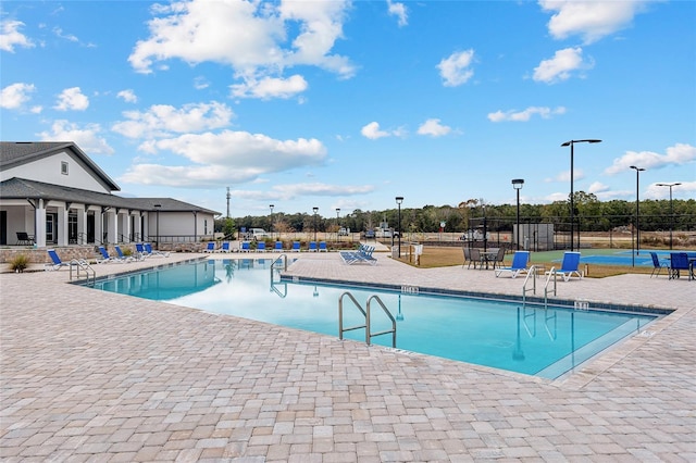 view of swimming pool with a patio