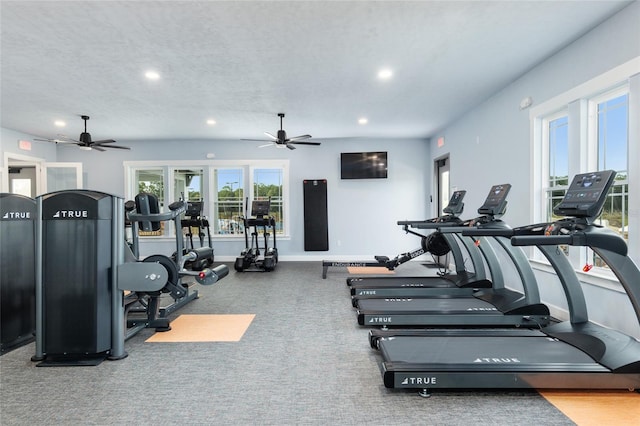 workout area with a textured ceiling and ceiling fan