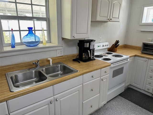 kitchen featuring white cabinetry, sink, and white electric range oven