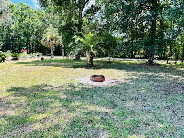 view of yard with an outdoor fire pit