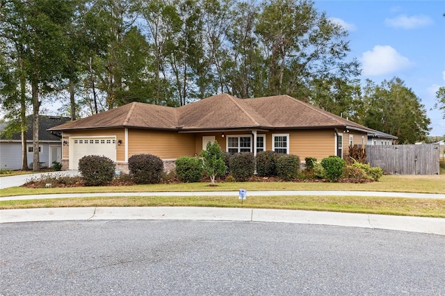 ranch-style home with a garage and a front lawn