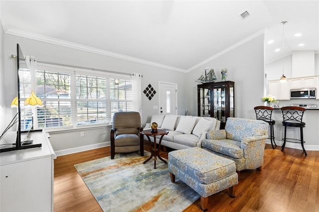 living room with dark hardwood / wood-style floors, ornamental molding, and lofted ceiling