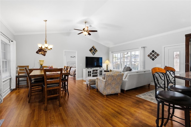 dining room with vaulted ceiling, ceiling fan with notable chandelier, crown molding, and dark wood-type flooring