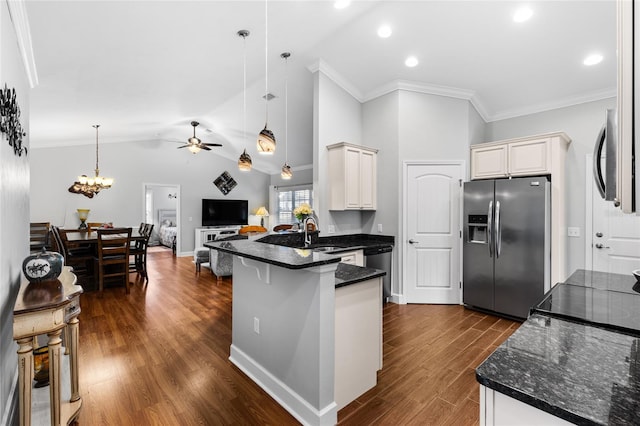 kitchen featuring hanging light fixtures, kitchen peninsula, dark wood-type flooring, stainless steel appliances, and lofted ceiling