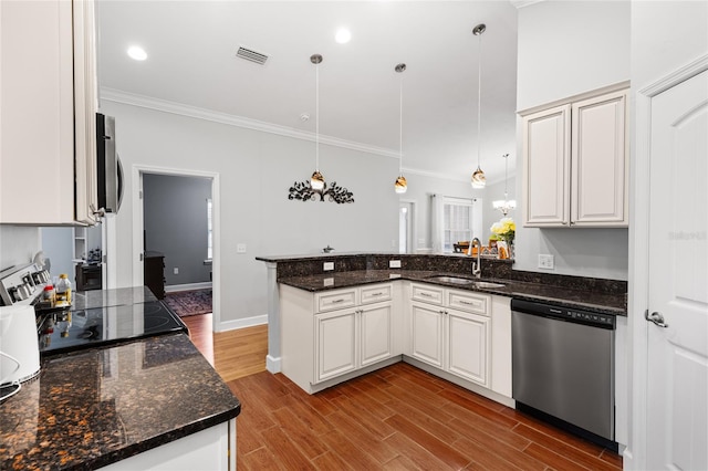 kitchen featuring dishwasher, stove, sink, decorative light fixtures, and kitchen peninsula