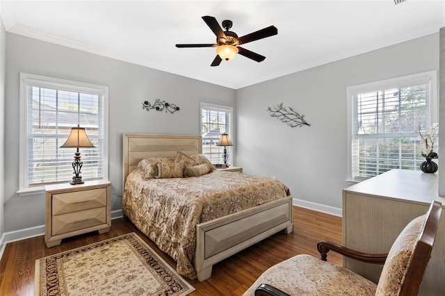 bedroom with ceiling fan, multiple windows, dark hardwood / wood-style floors, and crown molding