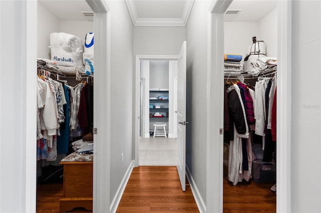 walk in closet with hardwood / wood-style flooring