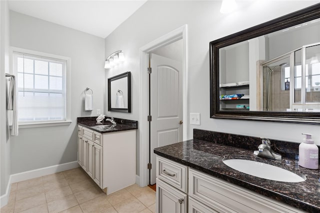 bathroom with walk in shower, tile patterned floors, and vanity