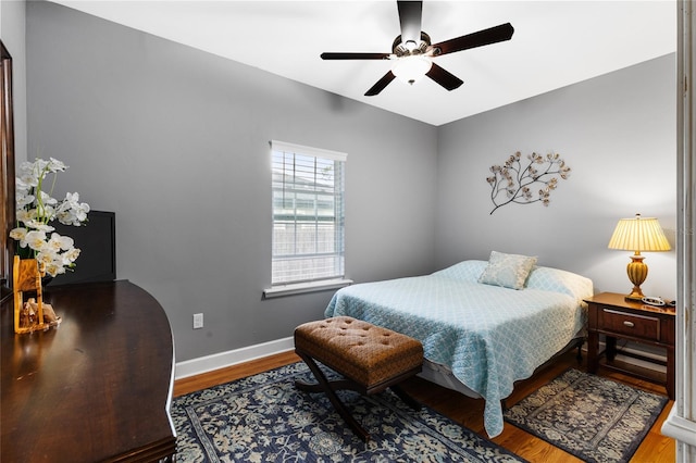 bedroom with ceiling fan and hardwood / wood-style flooring