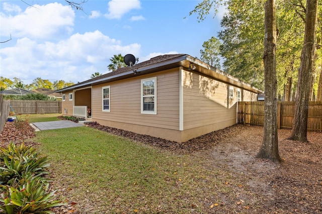 back of property featuring a patio area and a yard