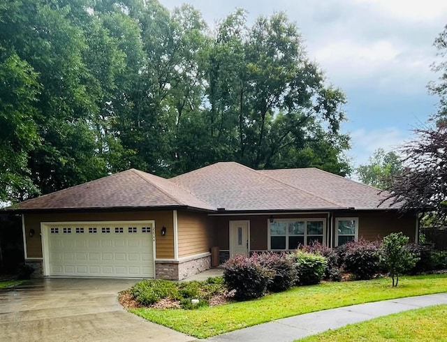 view of front facade with a garage and a front lawn