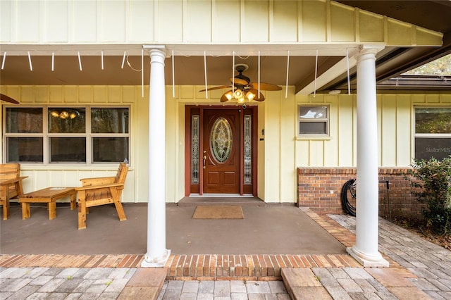 doorway to property with ceiling fan and a porch