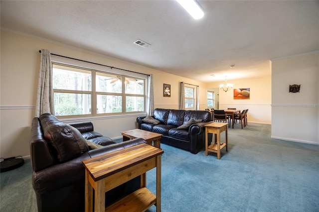 carpeted living room with crown molding and a notable chandelier