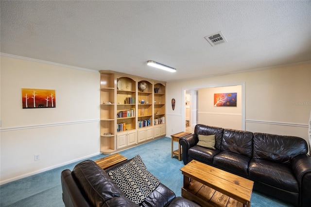 carpeted living room with built in shelves, crown molding, and a textured ceiling