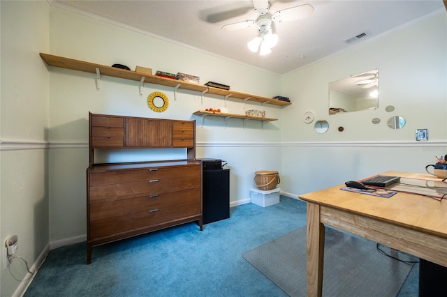 carpeted home office with ceiling fan and ornamental molding