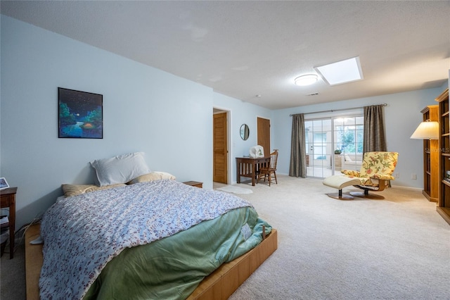 carpeted bedroom featuring a skylight