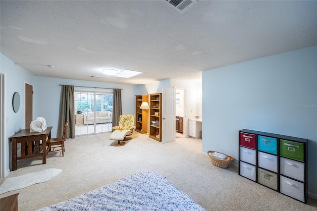 sitting room featuring carpet and a textured ceiling