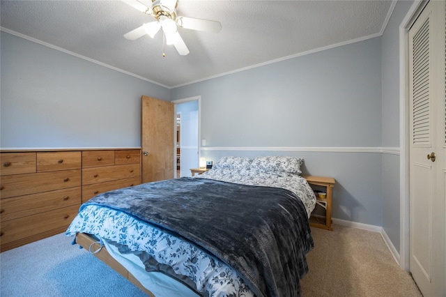 bedroom with crown molding, carpet flooring, ceiling fan, a textured ceiling, and a closet