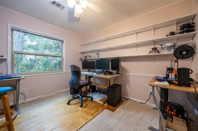 office space with light colored carpet and ceiling fan