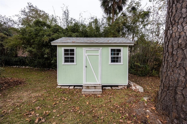 view of outbuilding with a yard