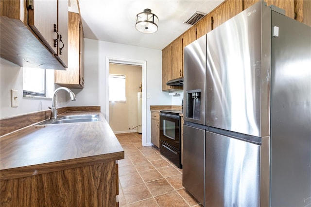 kitchen featuring stainless steel fridge with ice dispenser, sink, and black electric range