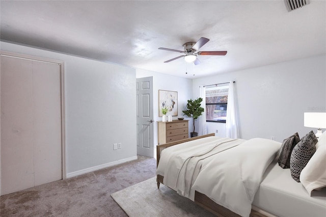 carpeted bedroom featuring a closet and ceiling fan