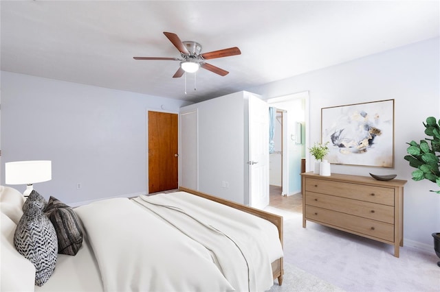 carpeted bedroom with ceiling fan and ensuite bathroom