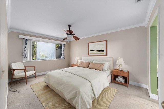 carpeted bedroom with ceiling fan and crown molding