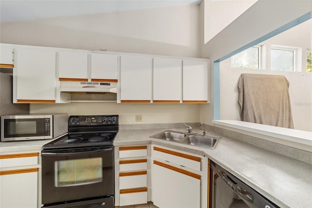 kitchen with appliances with stainless steel finishes, white cabinetry, and sink