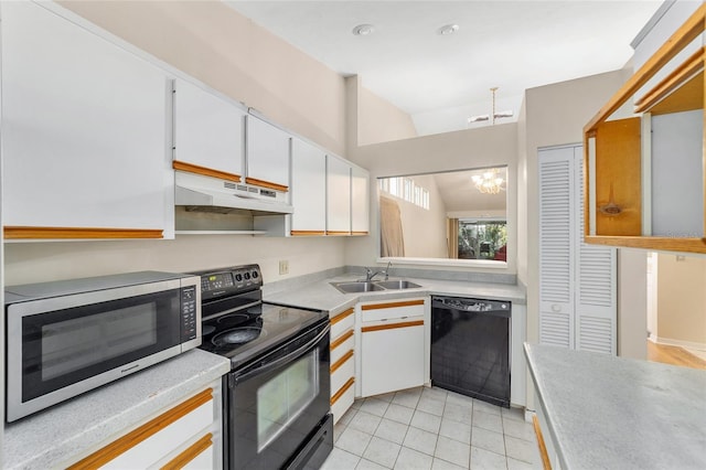 kitchen featuring vaulted ceiling, sink, black appliances, a notable chandelier, and white cabinets