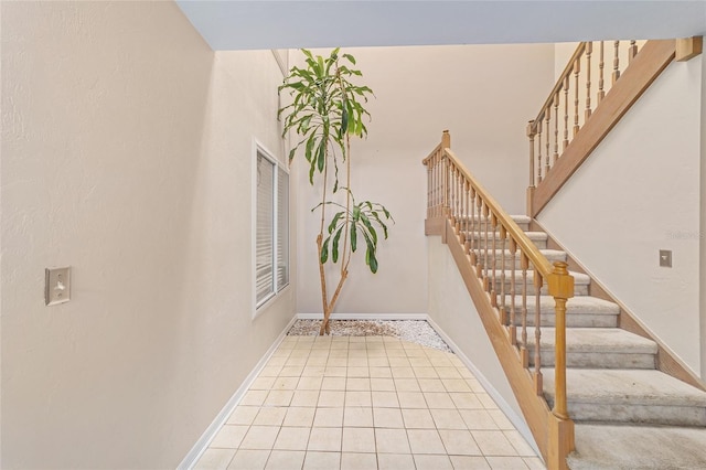 stairway with tile patterned flooring