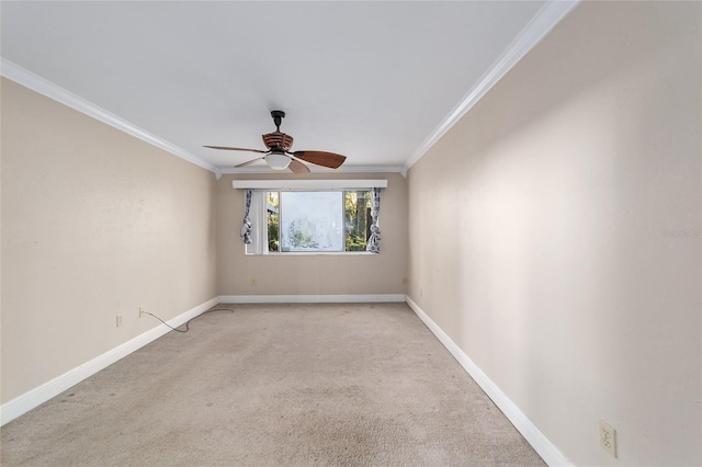 carpeted empty room with ceiling fan and crown molding