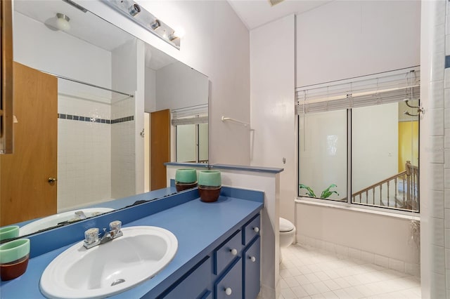 full bathroom with tile patterned floors, vanity, toilet, and bath / shower combo with glass door