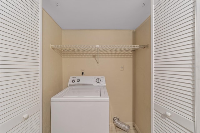 laundry room with washer / dryer and light tile patterned floors