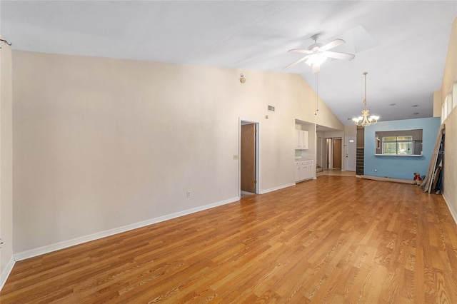 unfurnished living room with ceiling fan with notable chandelier, light hardwood / wood-style floors, and vaulted ceiling