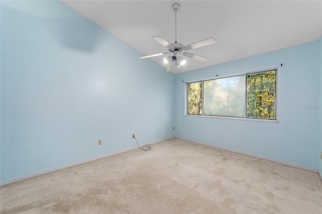 carpeted empty room with ceiling fan and vaulted ceiling