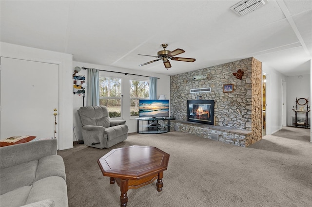 carpeted living room with a fireplace and ceiling fan