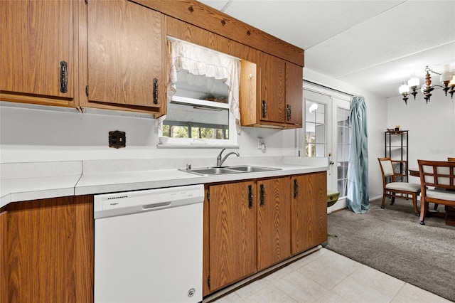 kitchen featuring dishwasher, light colored carpet, sink, and an inviting chandelier