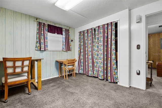 sitting room featuring carpet and a textured ceiling