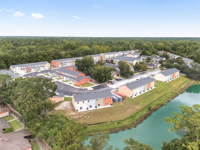 aerial view with a water view, a wooded view, and a residential view