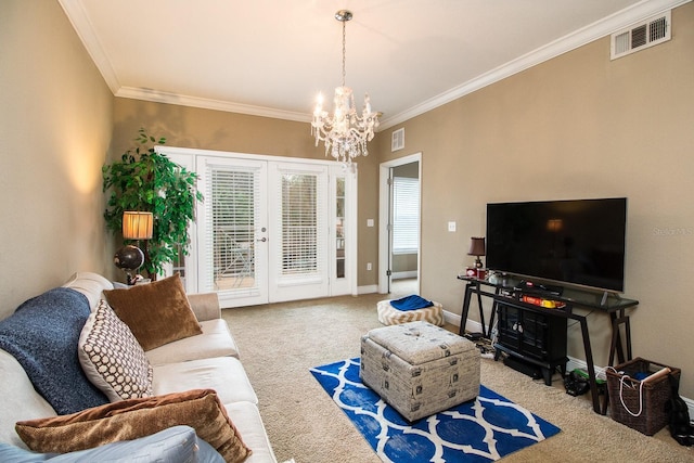 carpeted living room with french doors, ornamental molding, and a notable chandelier