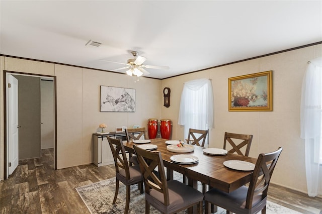 dining space featuring ceiling fan, dark hardwood / wood-style flooring, and ornamental molding