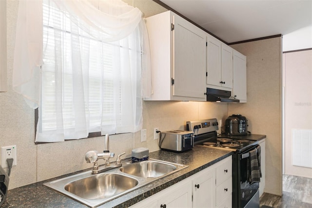 kitchen featuring stainless steel electric range, backsplash, dark wood-type flooring, white cabinets, and sink